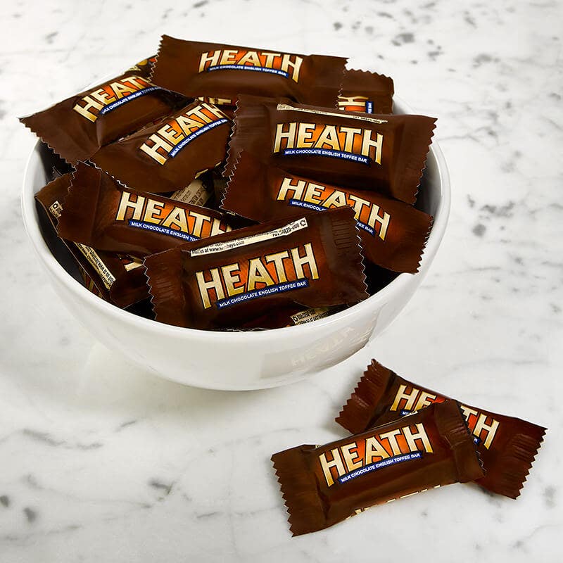 heath snack size candy bars in a white bowl. 